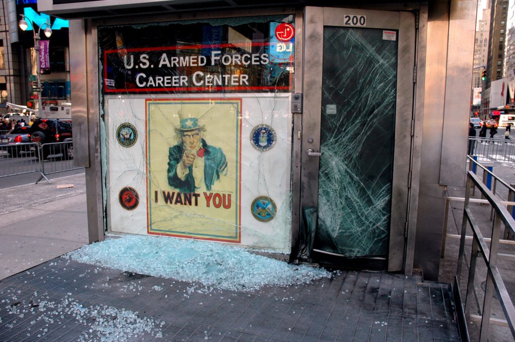 080306-M-0438D-002<br /> NEW YORK (March 6, 2008) An improvised explosive device blasted the entrance to the U.S. Armed Forces Career Center, a joint-service recruiting station located in Times Square at approximately 3:45 a.m. The blast caused no injuries; however, glass in the office's front door and window was shattered by the explosion, and the door's metal frame was bent. One of the busiest recruiting stations in the nation, the recruiting office is singularly located on a triangular island in the center of the iconic Manhattan intersection and has been the site of periodic anti-war protests. U.S. Marine Corps photo by Cpl. Karim Delgado (Released)